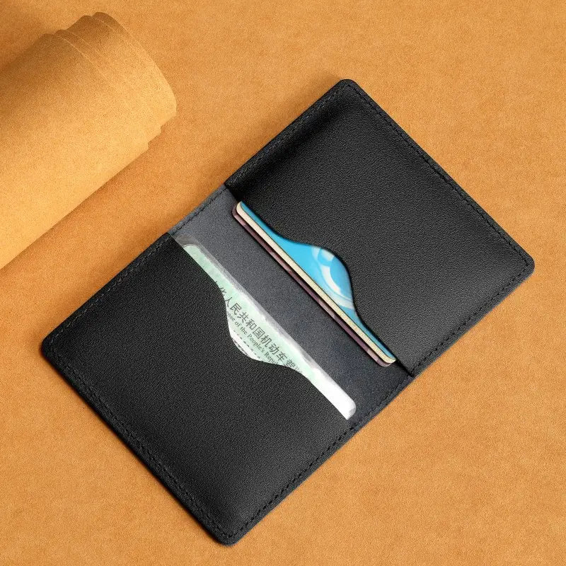 Black leather ultra thin genuine leather cowhide card holder wallet with stitched edges and two card slots.