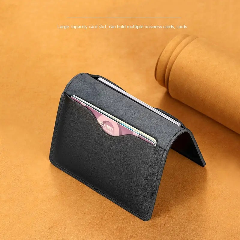 Black leather ultra thin genuine leather cowhide card holder wallet with multiple slots for business cards and credit cards.