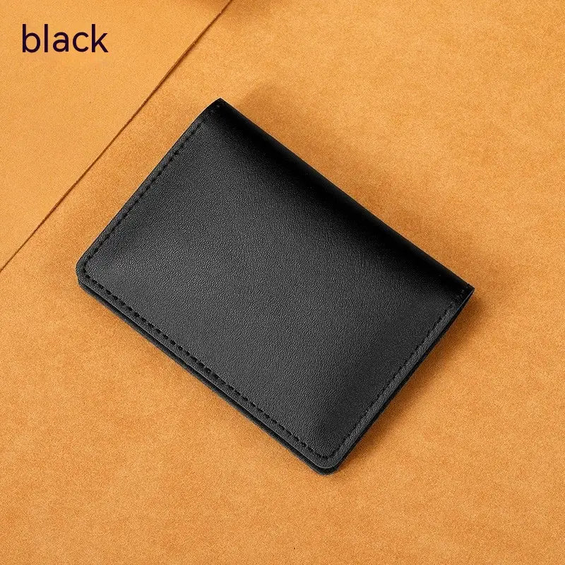 Black leather ultra thin genuine leather cowhide card holder wallet with neat stitching along the edges.