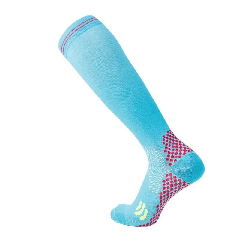 Light blue athletic compression soccer sock with pink and yellow accents and a textured footbed pattern designed for performance and support.