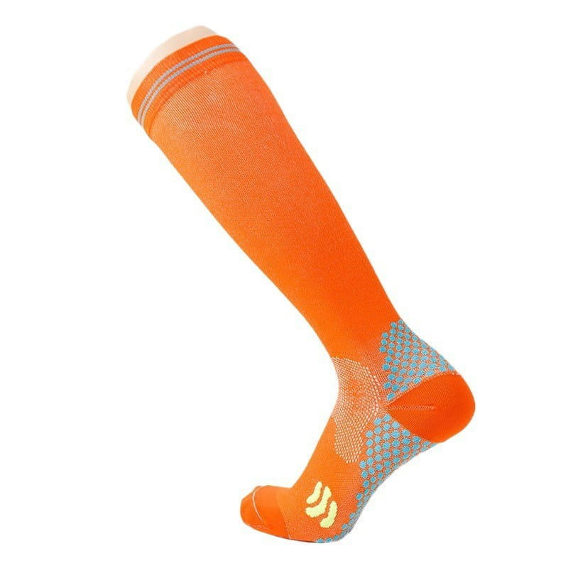 Bright orange compression soccer socks with gray and yellow accents featuring a textured grip pattern on the footbed for athletic use.