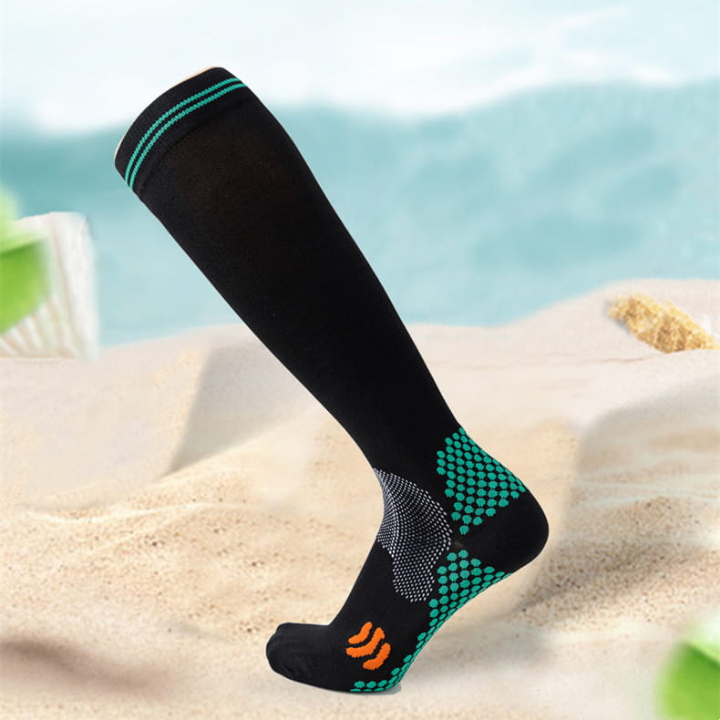 Black athletic compression soccer sock with teal and orange accents and textured pattern on the foot and ankle designed for enhanced performance.