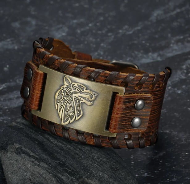 brown leather viking wolf braided leather buckle arm cuff with brass plate and silver toned studs featuring a fenrir wolf head design from asgard.