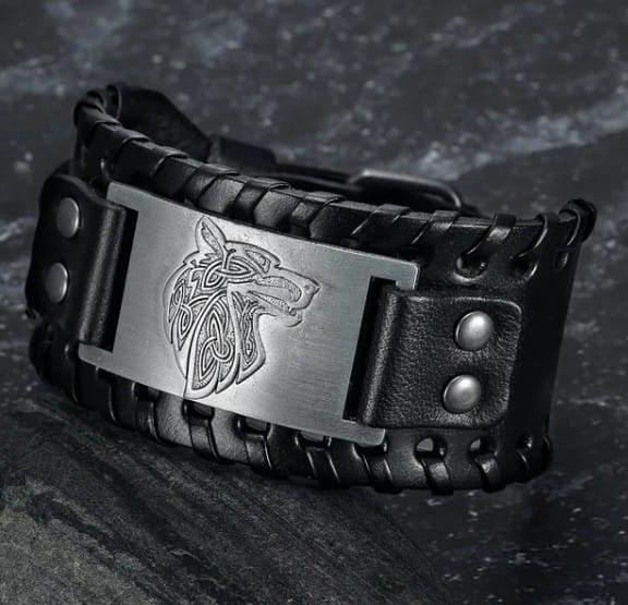 Black braided leather bracelet with a silver-toned rectangular plate featuring an engraved viking wolf head design from the Asgard Fenrir Viking Wolf braided leather buckle arm cuff.
