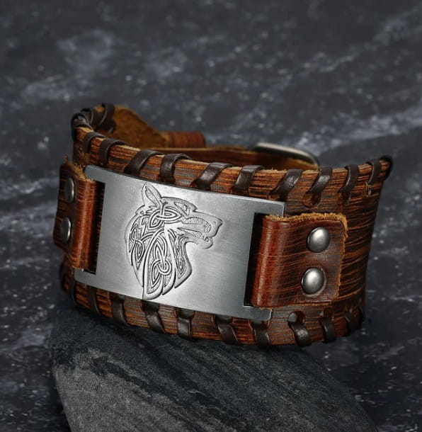 brown leather cuff bracelet featuring a silver-toned metal plate engraved with a viking wolf head design from the Asgard Fenrir Viking Wolf braided leather buckle arm cuff collection.
