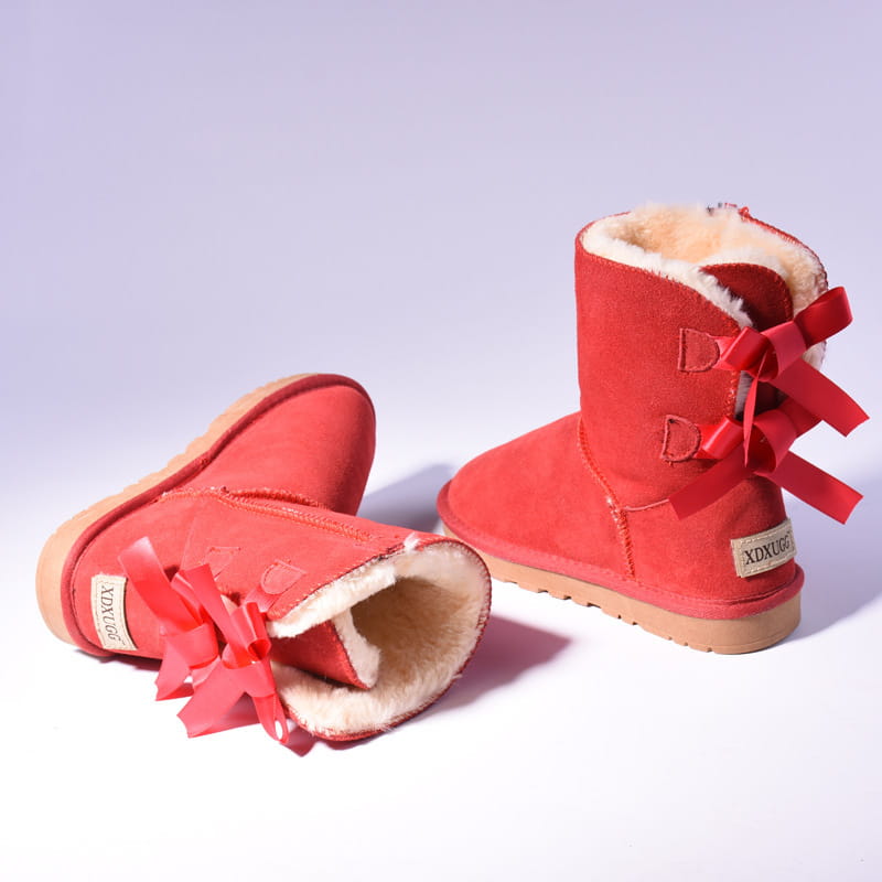 back side of women snow boots in red suede with warm fluffy shearling lining and matching red ribbon bows for winter wear