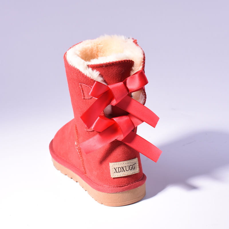 back view of women snow boots featuring warm red suede with plush white fur interior and a prominent red bow tied at the back for winter use