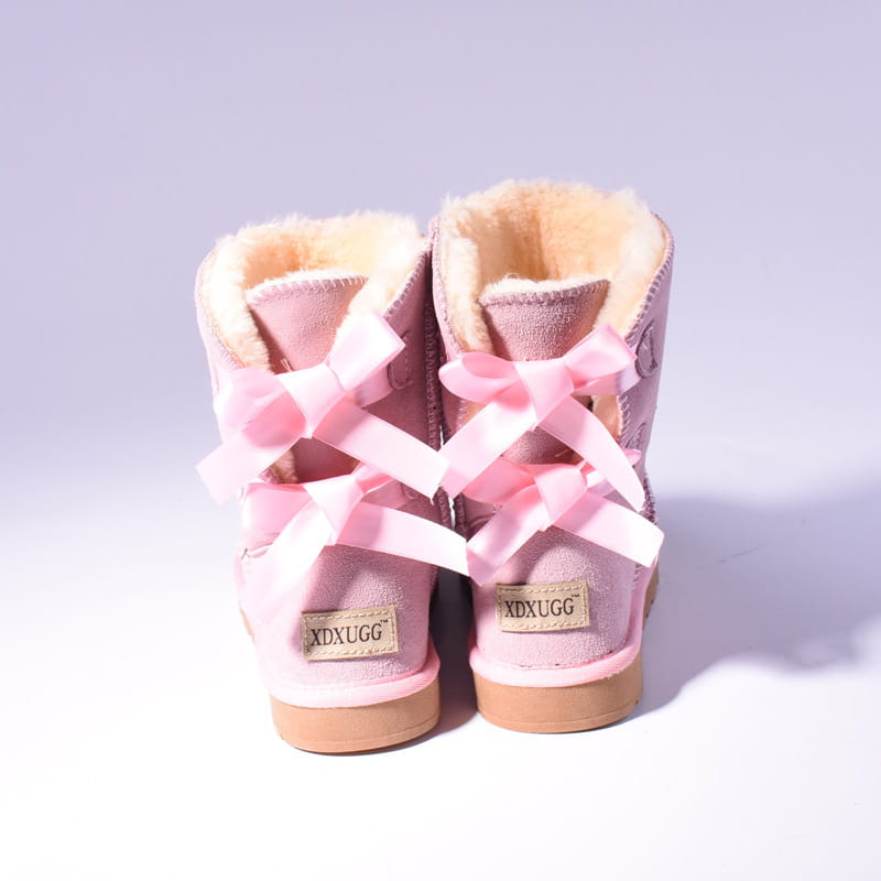 Women snow boots warm pink suede ankle boots with plush beige fur lining and satin bows tied across the front suitable for winter wear