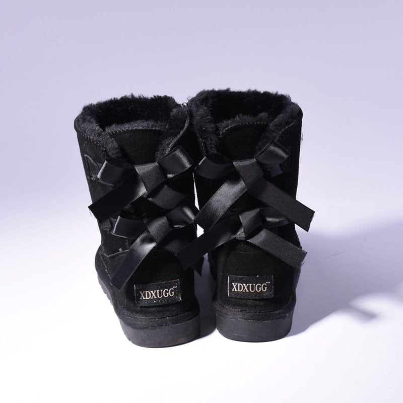 Black suede women snow boots with warm plush fur lining and decorative satin bows ideal for winter use.