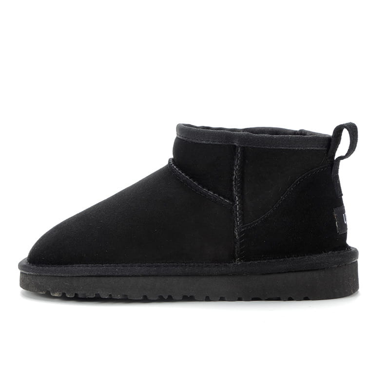 black suede sheepskin mini snow boot with plush interior and rubber sole designed as short shoes