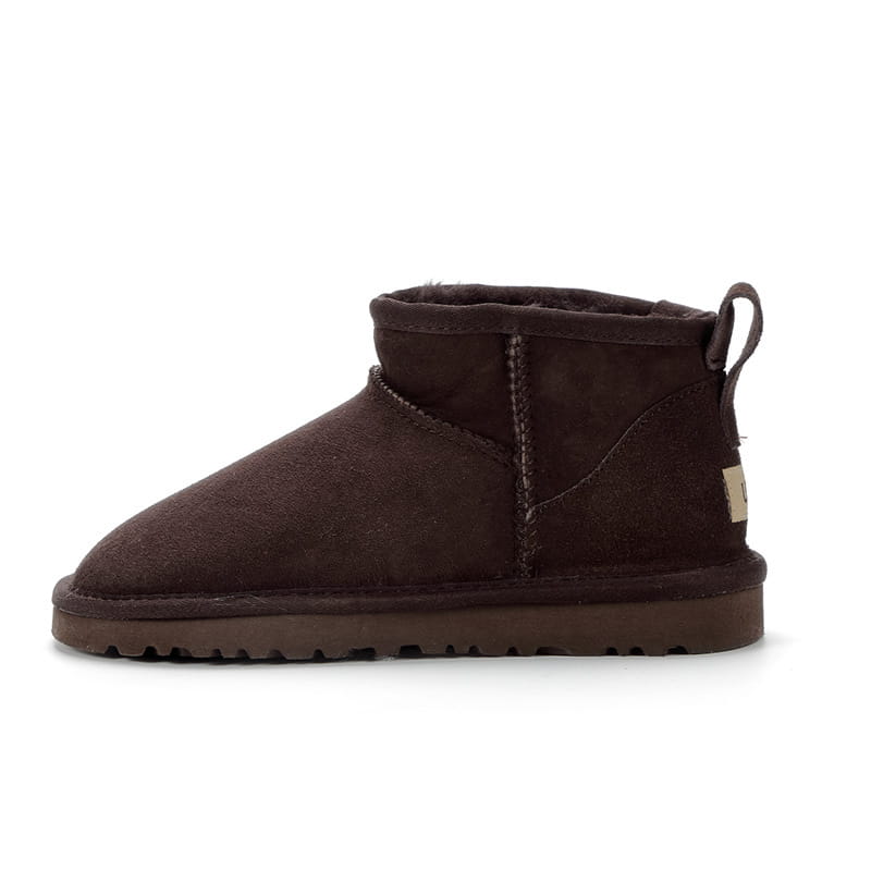 dark brown suede sheepskin mini snow boot with plush interior and pull tab at the back displayed from the rear side