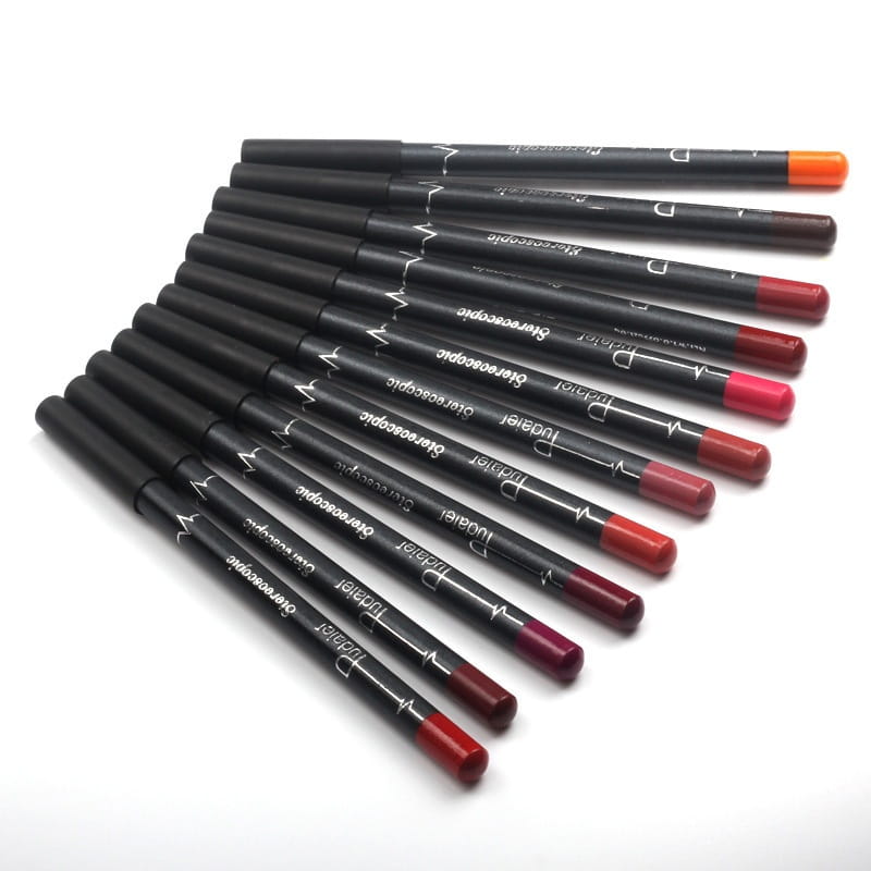 Set of ten black cylindrical Dior lip liner pencils with colorful waterproof matte tips in shades from red to orange for precise lipstick application.