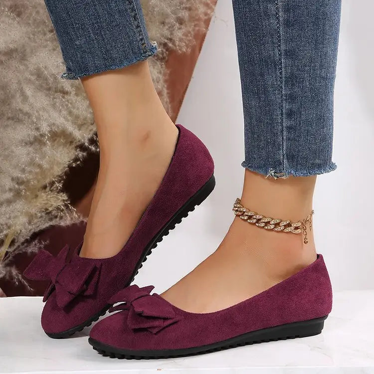 Women’s magenta suede bow round toe flat gommino loafers featuring matching bow accents for elegant wear.