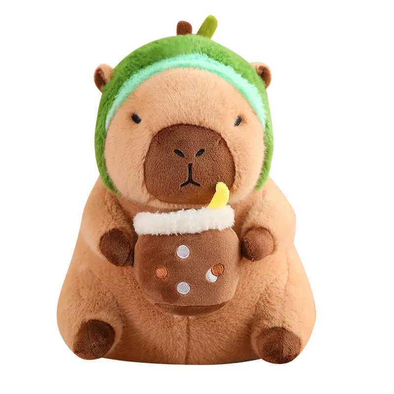 A plush capybara toy wearing a green hat with a light blue band and holding a brown boba tea cup decorated with white orange and silver polka dots in a bread and flower outfit.