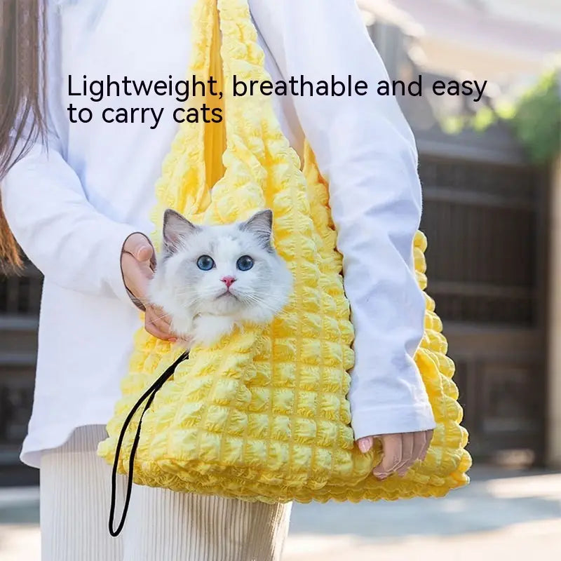 Bright yellow textured fabric plush animal pet carrier bag backpack with quilted design and black strap.