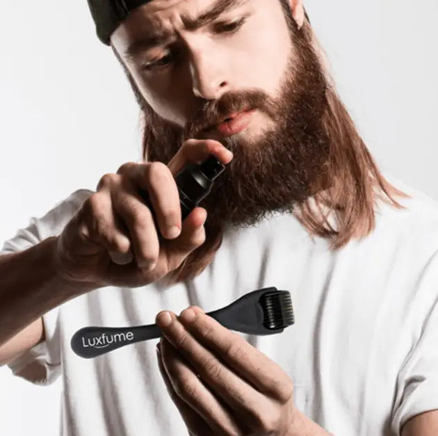 black luxfume beard dye applicator with brush head and spray nozzle shown as part of beard growth kit with derma roller and serum set