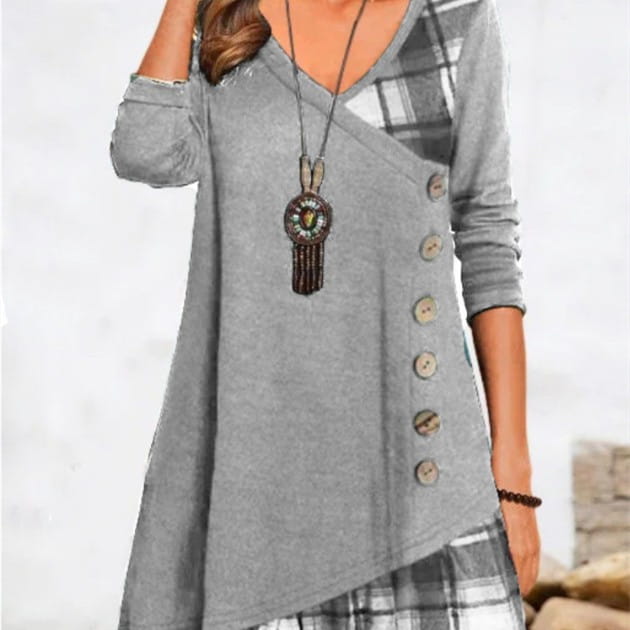 Gray v-neck knit tunic dress featuring an asymmetrical plaid patchwork panel and button detailing.