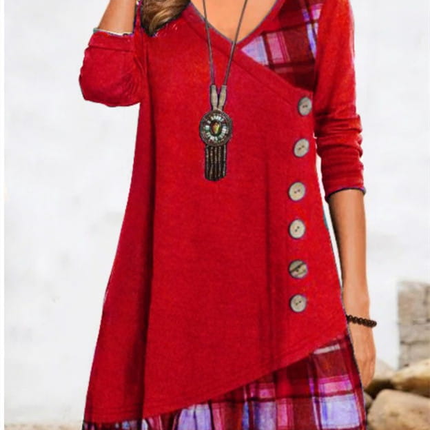 red asymmetrical knit tunic dress with plaid patchwork panels at the neckline and hem and decorative buttons down one side