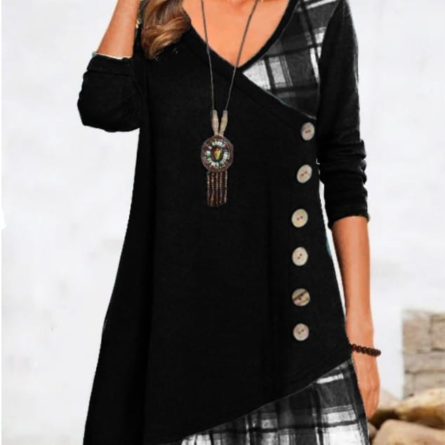 Black long-sleeved asymmetrical plaid patchwork knit tunic dress with decorative buttons down the front and plaid panels on the shoulder and side.