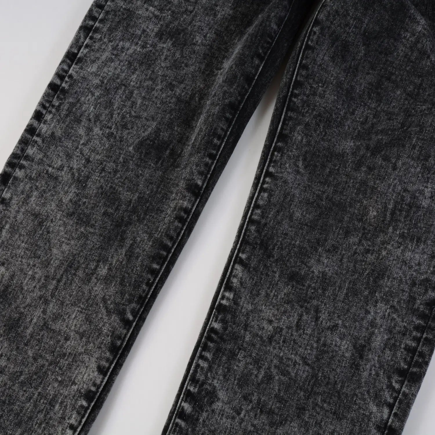 Men’s smoky gray slim fit distressed retro skinny jeans in black denim with a faded worn-in texture and visible stitching along the seams.