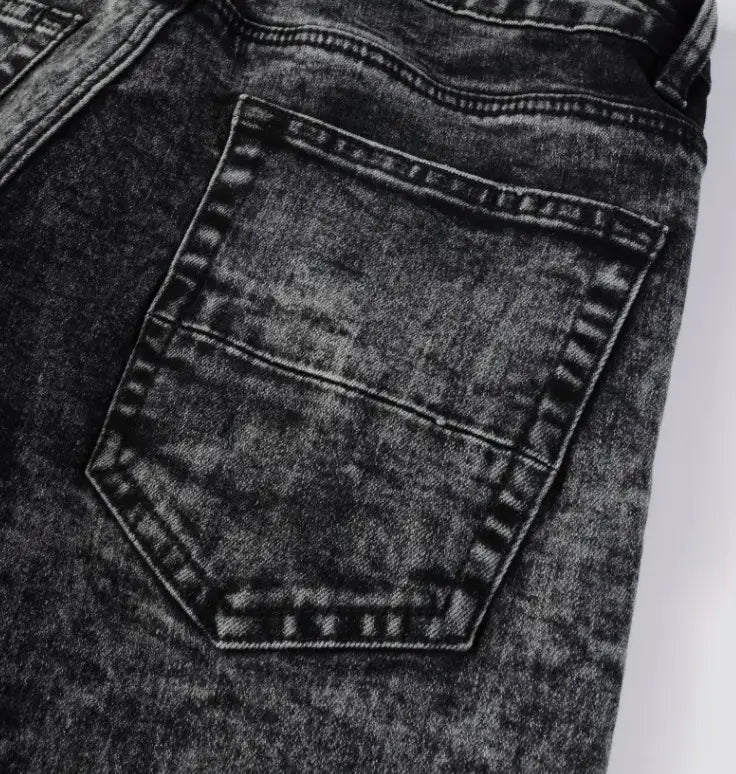 Men’s smoky gray slim fit distressed retro skinny jeans with dark-wash denim, faded texture, visible stitching, and classic back pocket design shown from the back side.