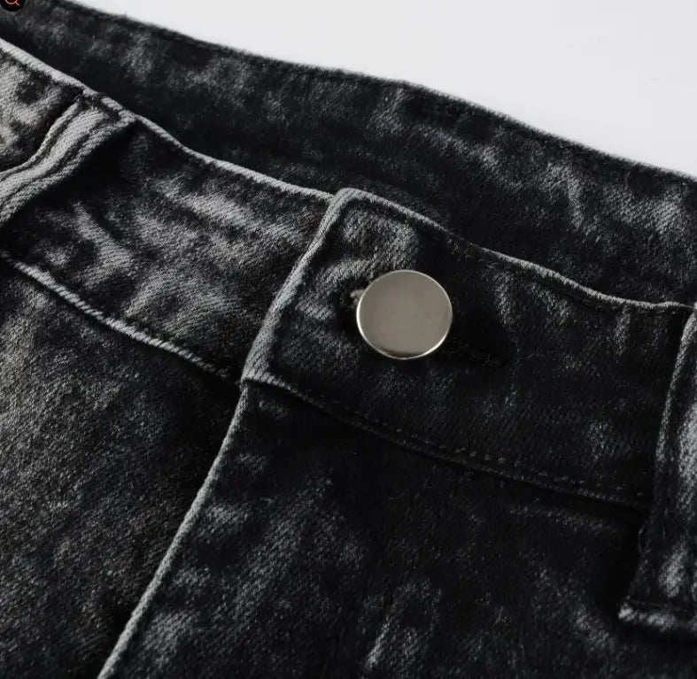men’s smoky gray slim fit distressed retro skinny jeans in black denim with a silver button at the waistband.