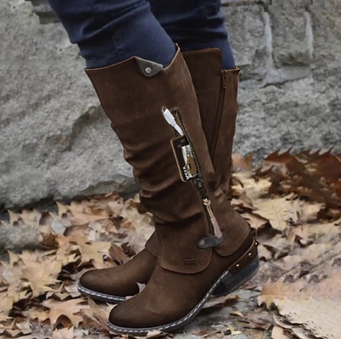 Knee high brown suede leather boots with block heel featuring a side zipper and metal accents.