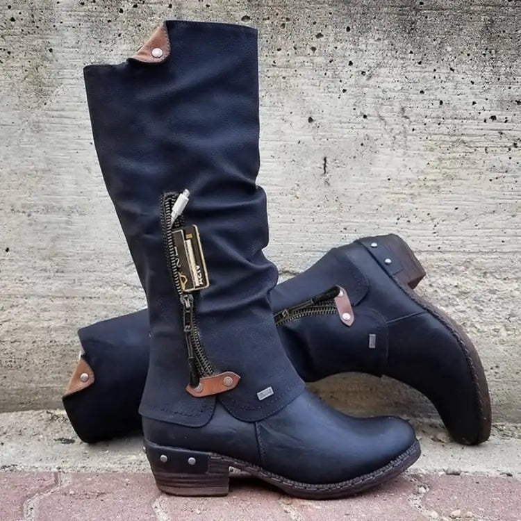 Dark blue knee high suede leather boots with brown accents and zippers featuring a block heel.