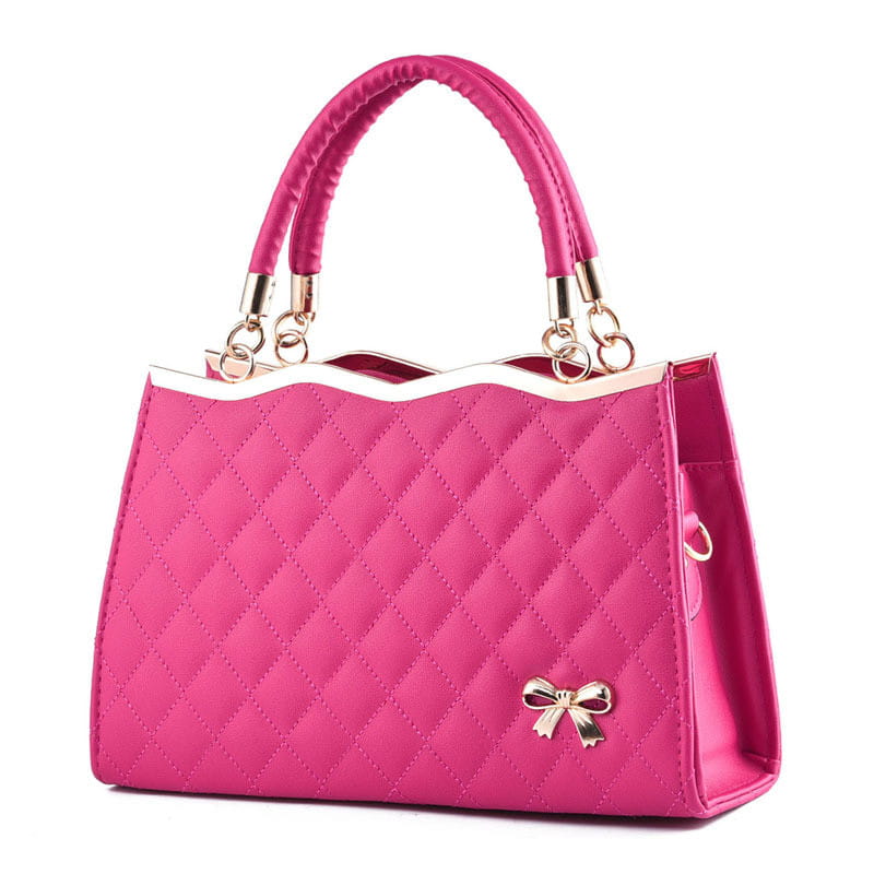 Vibrant pink quilted crossbody handbag featuring a gold-tone bow accent and matching handles with gold hardware.