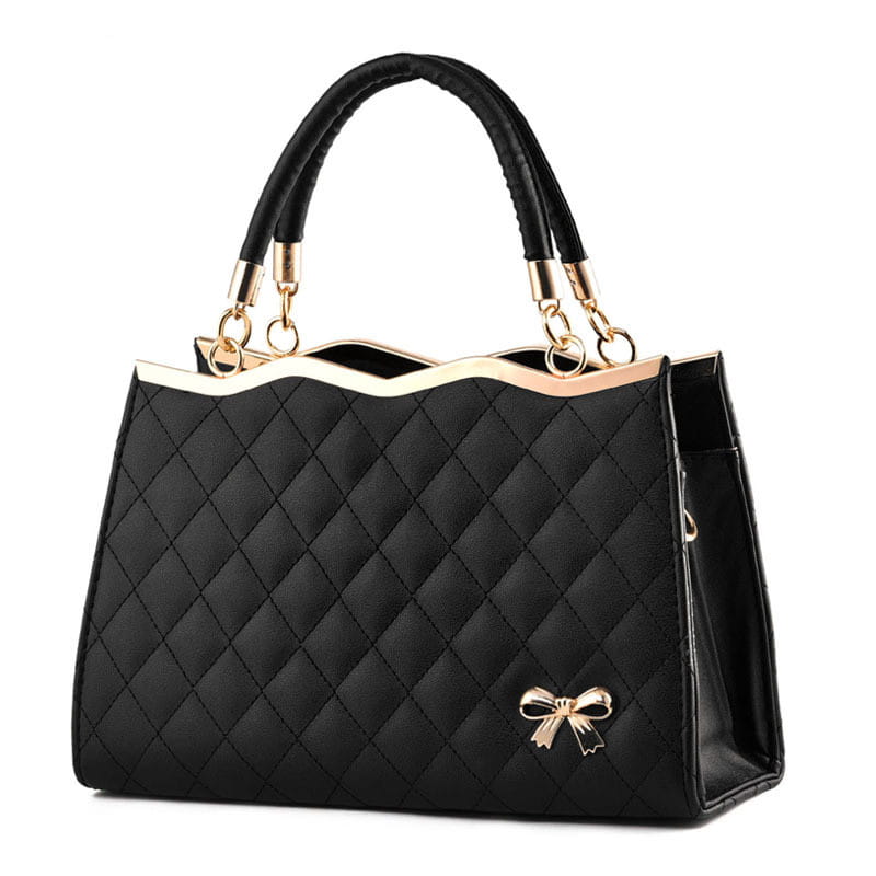 Black quilted crossbody handbag with gold-tone hardware and decorative bow accent.