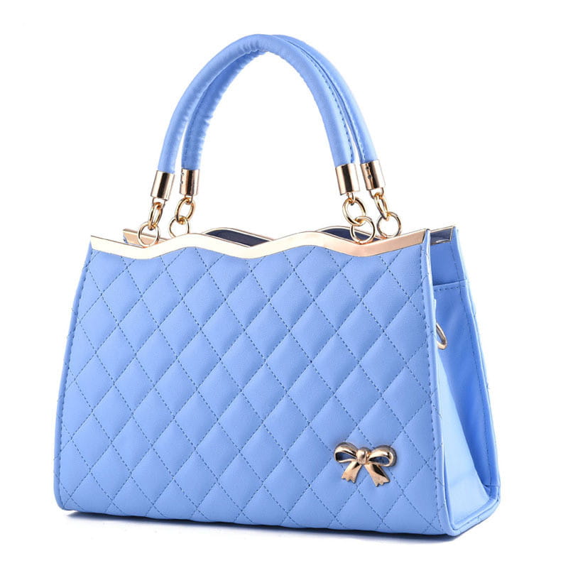 Light blue quilted crossbody handbag featuring a gold-tone bow and hardware.