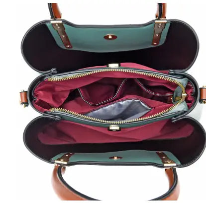 Pu leather shoulder bag with detachable strap in teal and burgundy two-tone design featuring brown leather handles and gold-toned hardware.