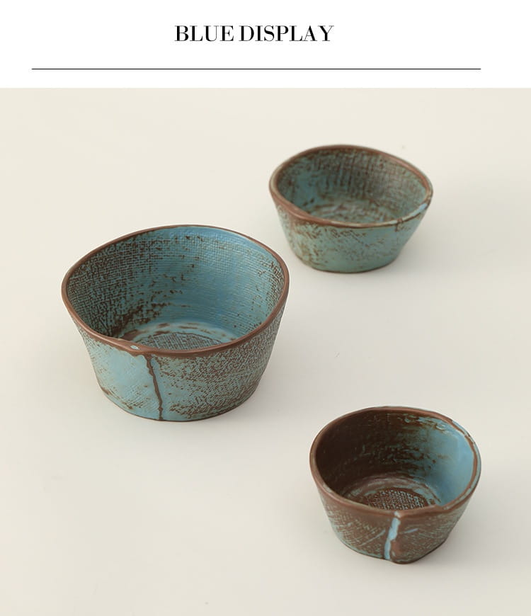 Set of three handcrafted ceramic rice and soup bowls with rustic textured surfaces and distressed blue glaze.