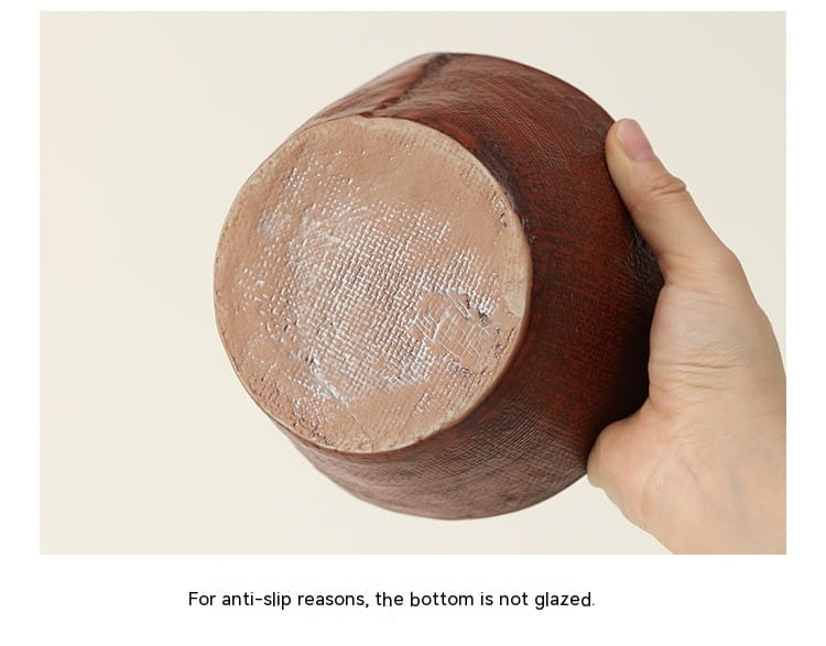 A rustic brown ceramic rice bowl with a textured unglazed bottom for grip, handcrafted with a retro design suitable for soup.