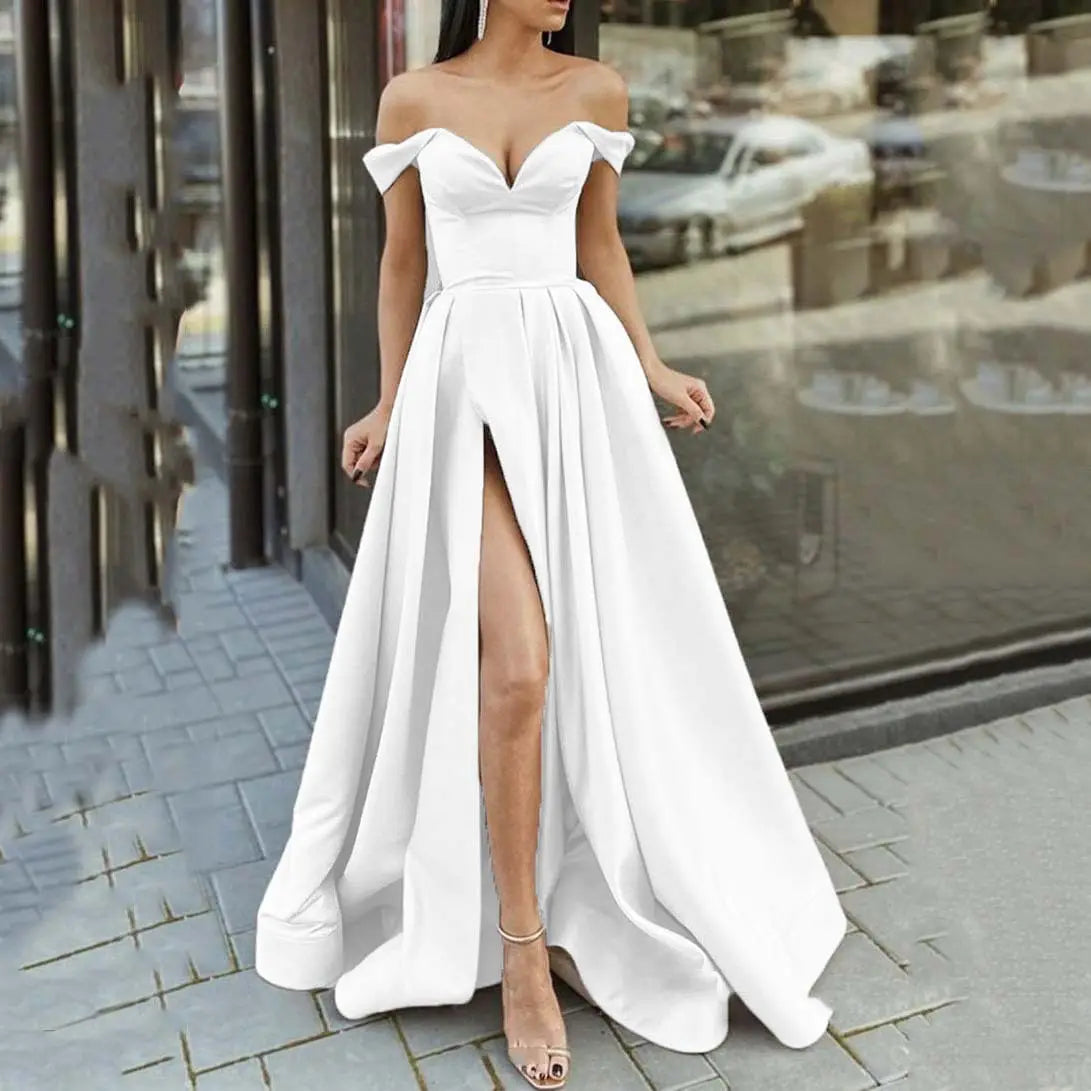 White satin off-the-shoulder maxi dress with v neck, high slit, and pleated skirt perfect for elegant occasions.