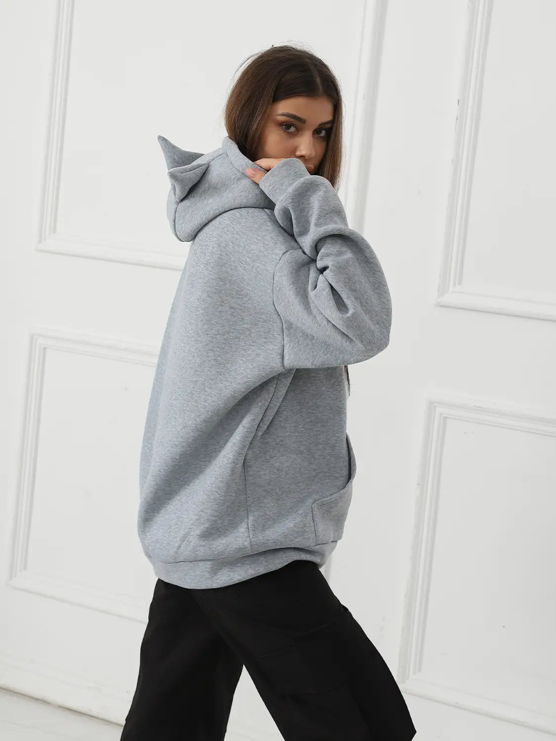 A soft heather gray women’s dalmatian print hoodie featuring a distinctive cat ear hood design.