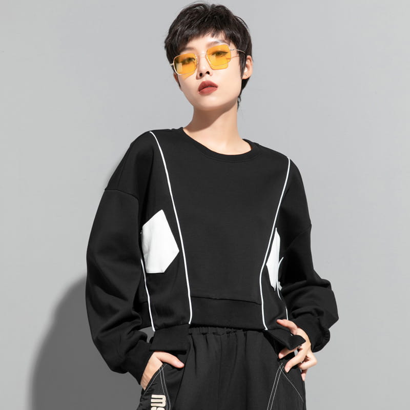 Sweat-shirt oversize noir avec panneaux géométriques blancs et surpiqûres contrastantes, issu de la collection de pull à capuche irrégulier en patchwork pour vêtements pour femmes.