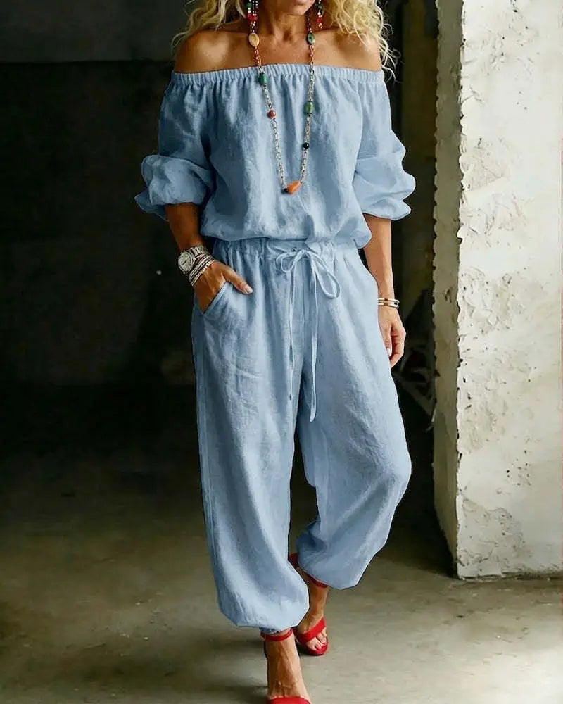 Light blue linen off-shoulder jumpsuit set featuring a drawstring waist and loose tapered legs.