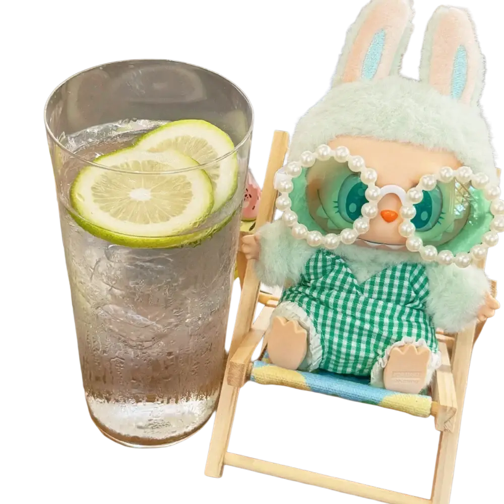 A mint-green plush 17cm labubu doll wearing pearl glasses and a green checkered outfit seated in a wooden beach chair