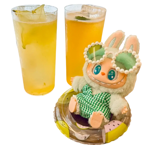 A 17cm labubu doll plush figurine with mint-green hair pearl headband and green checkered outfit in a clear container