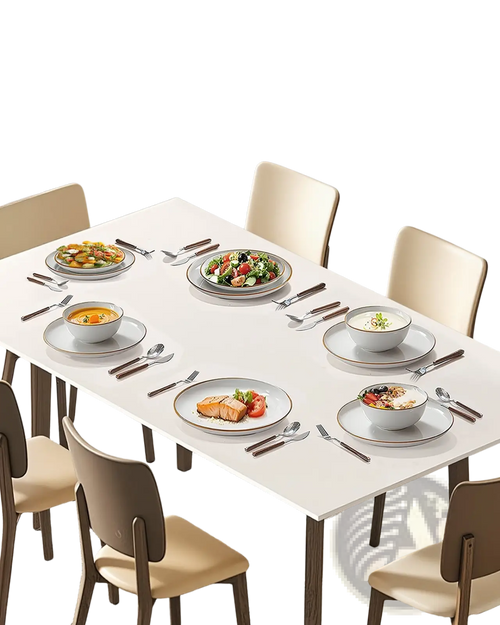 A minimalist white rectangular dining table with sleek modern legs paired with an 18 piece white ceramic dinnerware set with gold rim