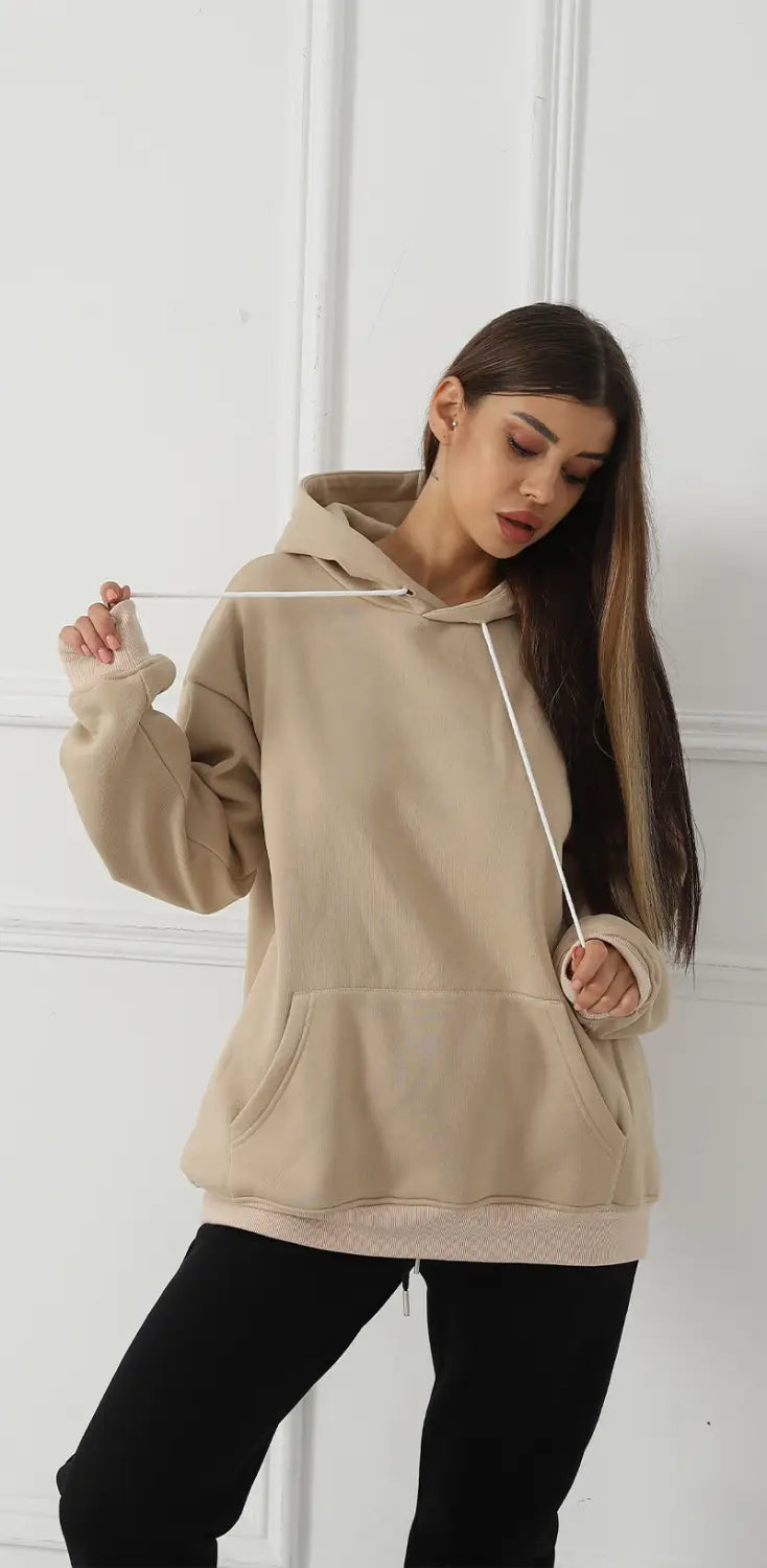 Beige oversized women’s hoodie with drawstring hood and front pocket featuring graphic print art.
