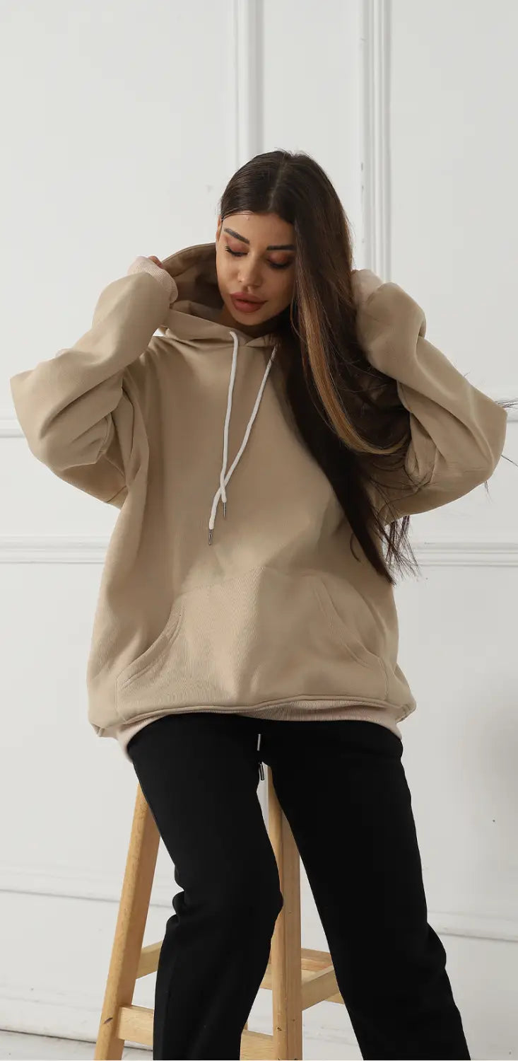 Beige oversized women’s hoodie with white drawstrings and a front pocket featuring graphic print art.