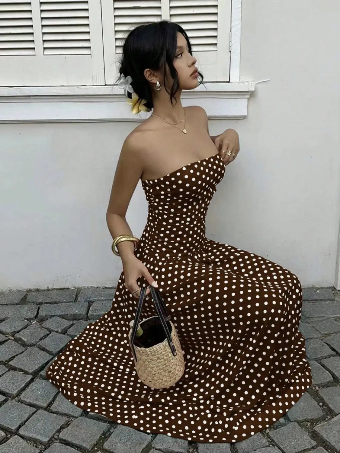 brown and white polka dot strapless maxi dress featuring an off shoulder design made from lightweight fabric ideal for casual or formal wear