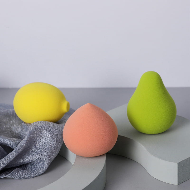 Three colorful hydrophilic makeup sponges in yellow peach and lime green teardrop shapes for beauty blender use.