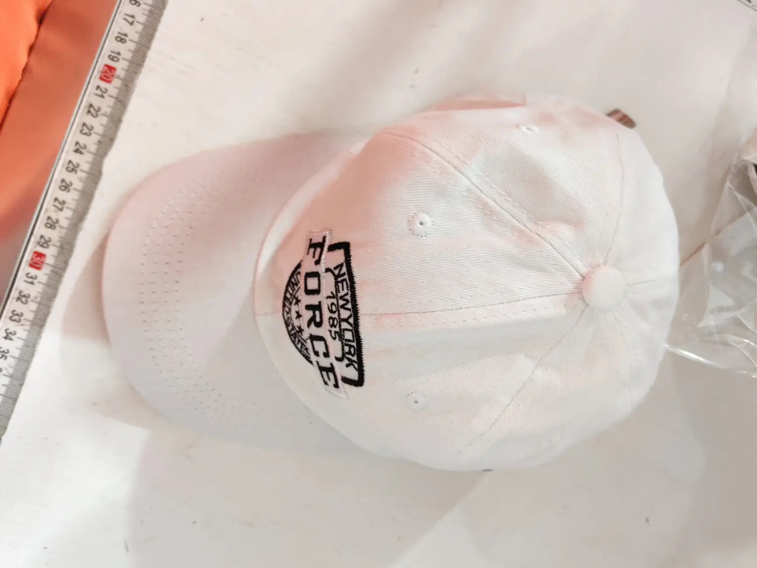 White baseball cap featuring black embroidered New York Force logo prominently on the front.