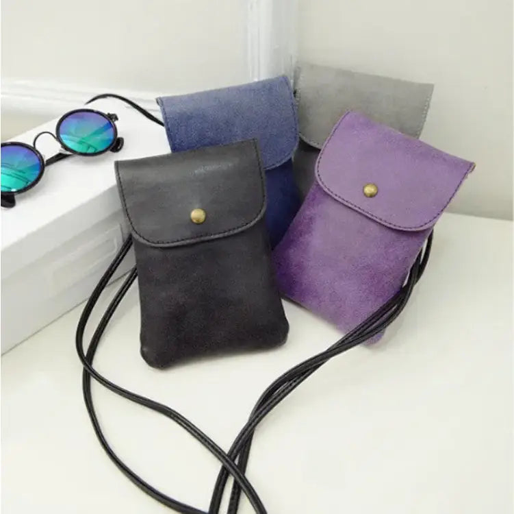 Black suede vegan leather crossbody phone pouch with gold-tone snap button closure from Old Worldly Charm matte suede collection.