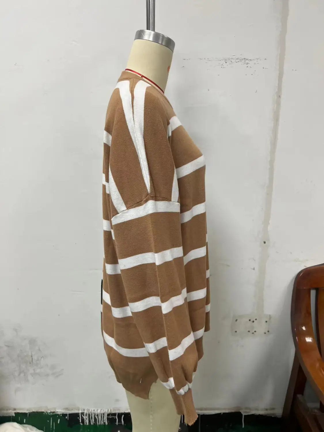 Women’s oversized split color striped knit sweater featuring cozy brown and white horizontal stripes with a ribbed neckline, cuffs, and hem.