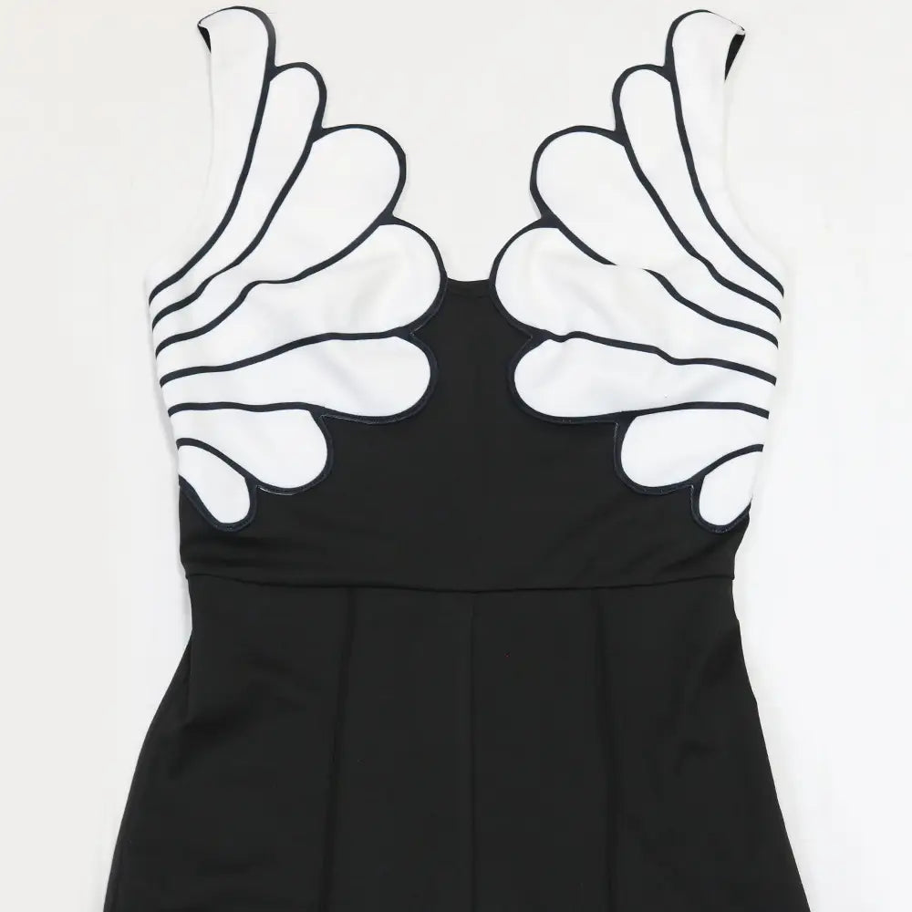 Black sleeveless butterfly wing slim fit jumpsuit featuring bold white handprint appliqués with black outlines on the upper chest.
