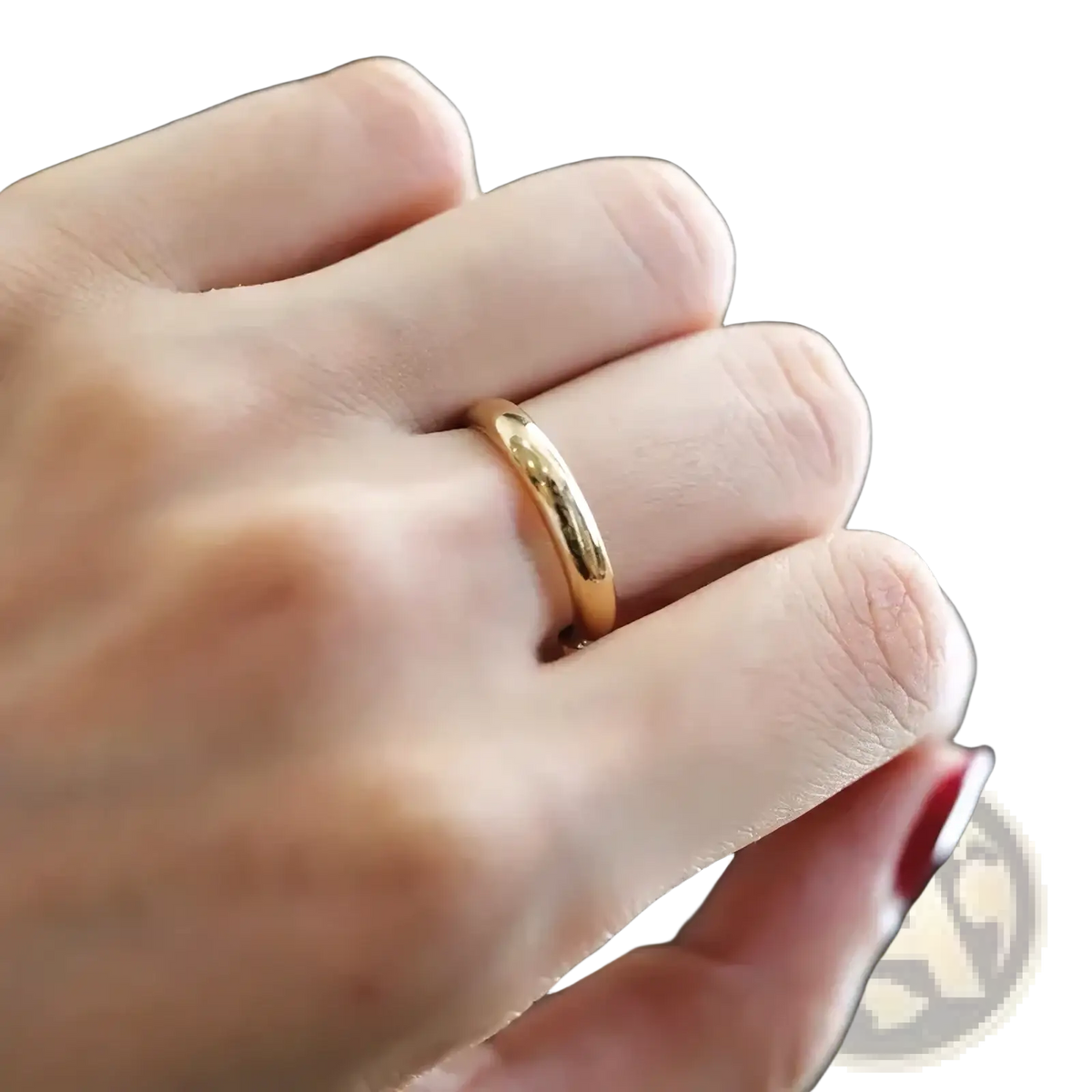 A sleek polished 18k gold 4mm wedding band ring worn on a finger for couples